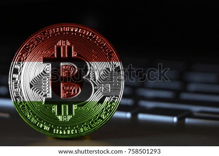 Bitcoin close-up on keyboard background, the flag of Niger is shown on bitcoin.