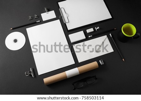 Blank corporate stationery set on black paper background. Template for branding ID. For graphic designers portfolios. Top view.
