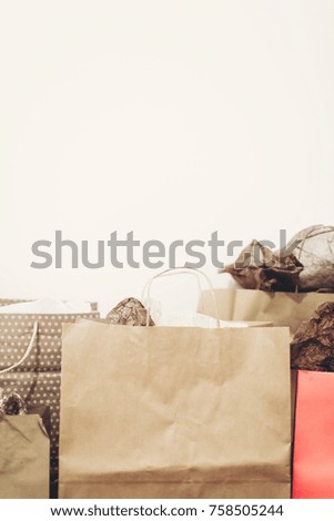 shopping, christmas shopping concept, space for text. big sale. many brown paper bags with presents on background of white wall. black friday, seasonal sale