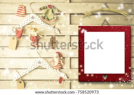 Christmas photo frames cards, empty picture frame hanging on a rustic wall and cute hangers, Santa Claus rag doll and xmas decoration.