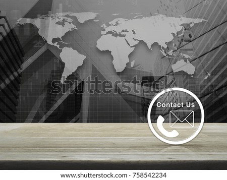 Telephone and mail icon button on wooden table over world map with financial graph and modern city tower, Business concept and idea, Elements of this image furnished by NASA