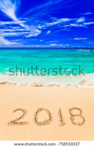 Numbers 2018 on beach - concept holiday background
