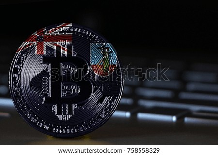 Bitcoin close-up on keyboard background, the flag of Montserrat is shown on bitcoin.