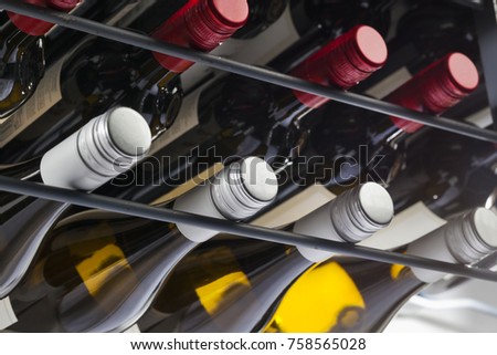 Storage of quality wine bottles with screw caps in a wine rack Royalty-Free Stock Photo #758565028