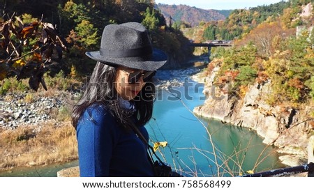 Asian woman posing for picture in National park in Japan.