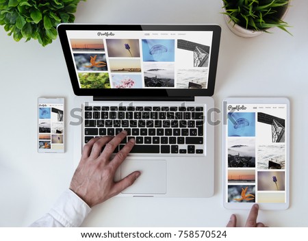 office tabletop with tablet, smartphone and laptop showing photo portfolio website