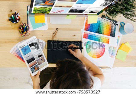 girl checking portfolio at design studio Royalty-Free Stock Photo #758570527