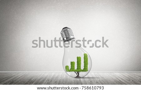 Glass lightbulb with growing green graph inside in empty room with grey wall on background. 3D rendering.