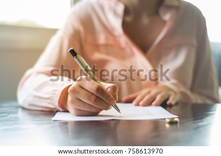Great concept of divorce, end of relationship, young woman signing divorce agreement. Royalty-Free Stock Photo #758613970