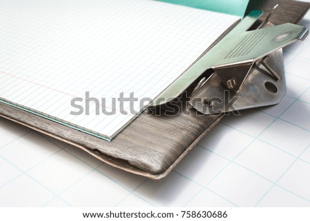 School notebook on a brown folder with clip