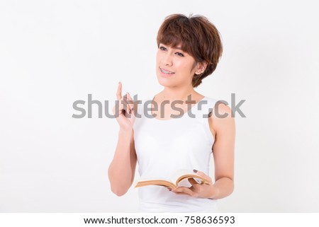 Young Asian woman with a book.  Isolated on white background. Studio lighting. Concept for education
