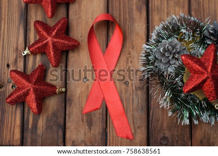 Shiny red satin ribbon on a Christmas table, a symbol of the fight against AIDS, Christmas background