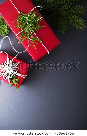 Christmas handmade red gift boxes on dark grey background top view. Merry christmas greeting card. Winter xmas holiday theme. Happy New Year. Flat lay.