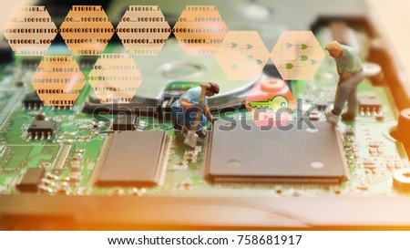 Blurred image of miniature mini  figures technician repairing inside of hard disk. Integrated Circuit. the concept of data, hardware, technician and technology. Data  security