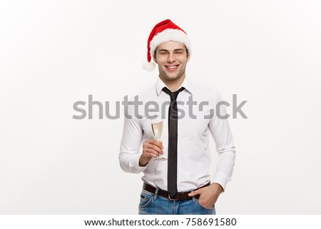 Christmas Concept - Handsome Business man celebrate merry christmas and happy new year wear santa hat with glass of champange.