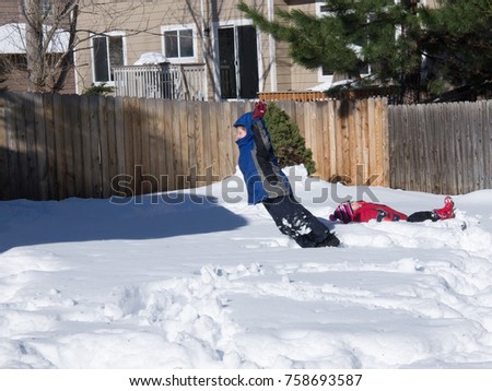 Children Playing in Deep Snow in a Denver Backyard