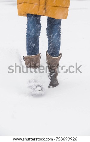Legs of running girl in winter