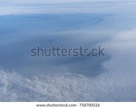 Blue sky, white cloud and the ocean forming a heart shape