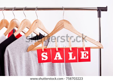 Sale in a clothing store - discount sign at a clothes rack