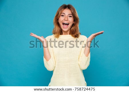 Picture of surprised happy young smiling woman isolated. Looking camera.