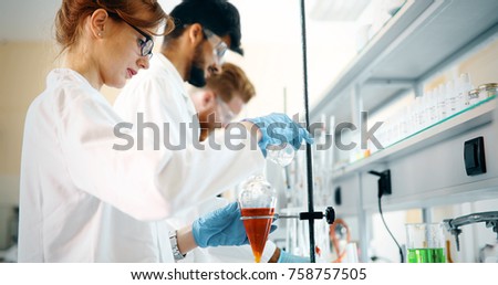 Young students of chemistry working in laboratory