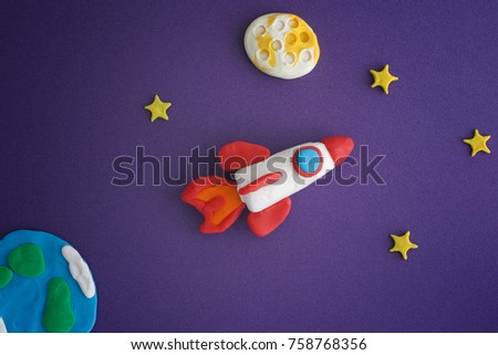 Space Rocket Blasting Off For New Ideas. Earth, space rocket, Moon and stars are made out of play clay (plasticine).