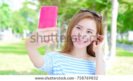 beauty woman selfie happily in the park