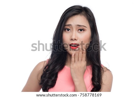 Surprised face of young asian woman over white.