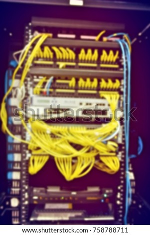 blurred image of severs computer in a rack at the large data center.