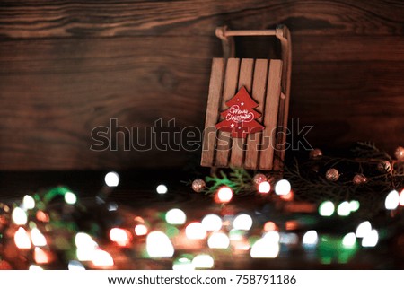 sled  and Christmas decor on the wooden background.