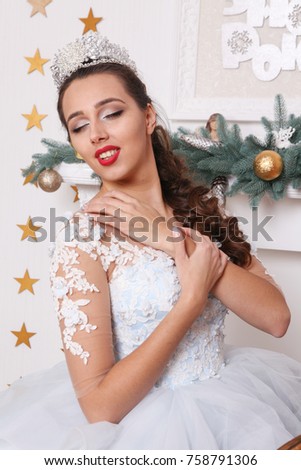 Beautifull girl near christmas tree with gift
