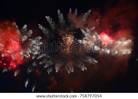 In the night sky fireworks explosions have created a fantastic picture of flying fires.
