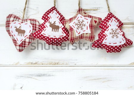 Christmas Card with Hanging Fabric Heart,Pine Tree and Star on a White Wooden Background