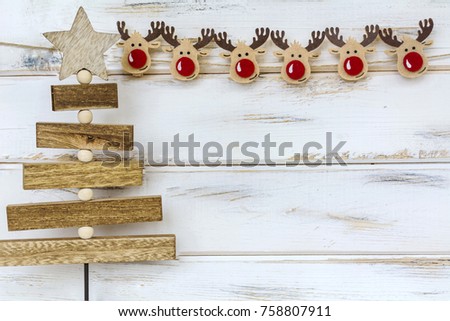 Christmas Pine Tree and Deer on a White Wooden Background
