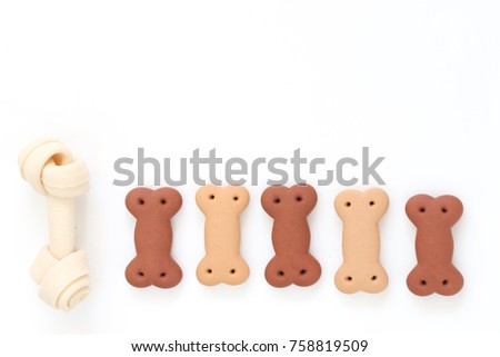 Delicious of dog biscuits , dog snack or dog  chew copy space on the white background, Can use background for web or product design and Advertising for pet food, etc. Royalty-Free Stock Photo #758819509