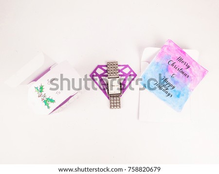 Flat Lay style of Christmas decoration with opened tsquare gift box with silver watch and greeting card for celebration best Christmas holidays background image for invitation
