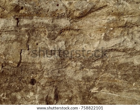 Close up detailed straight on view full color photo of aged ancient rough stone surface background texture
