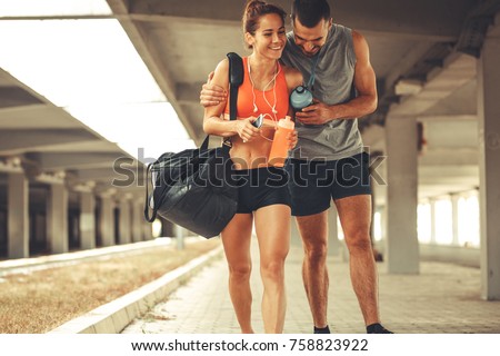 Young couple walking on street in sports wear.They going to gym. Royalty-Free Stock Photo #758823922