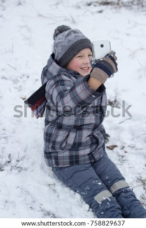 boy selfie photo in the winter,One boy photographs himself on a smartphone