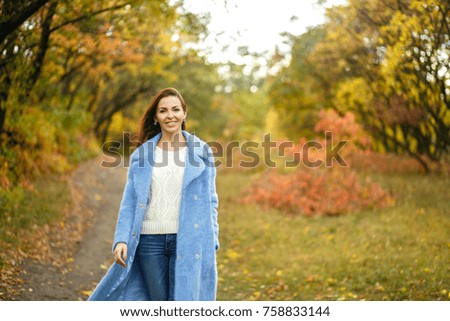Girl walking in autumn park