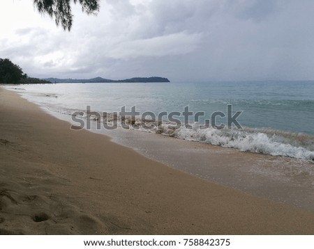 Sand beach with blue sea.  the beach at the seaside has a white sand , blue sky and clear water