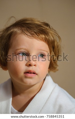 Portrait of a child. Emotions of the child: joy, despondency, irritation. A series of pictures on a sand color background.