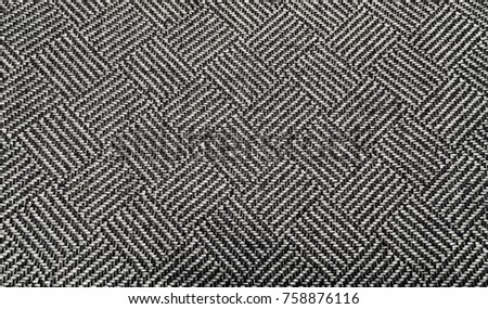 Close up detailed photo of textured diamond shaped knit fabric parallel line pattern background surface