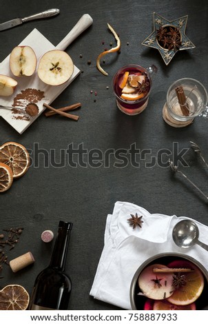 Ingredients for Hot mulled wine with apple, orange, anise and cinnamon with fresh fruits on wooden table. Winter and fall. Christmas and holidays food.