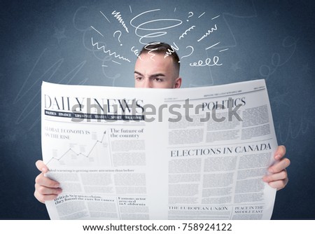 Confused businessman holding newspaper 