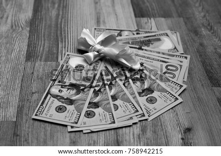 Black White photo of American cash, dollars. Gift