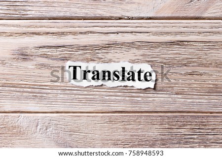 Translate of the word on paper. concept. Words of Translate on a wooden background.