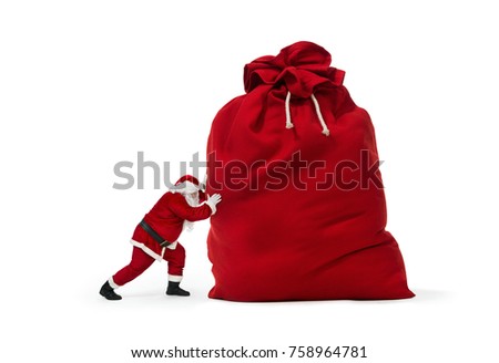 Close up of Santa Claus pushing huge bag of presents isolated on white background