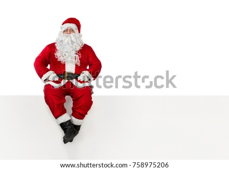 Santa Clause sitting at the edge of a banner isolated on white background with copy space