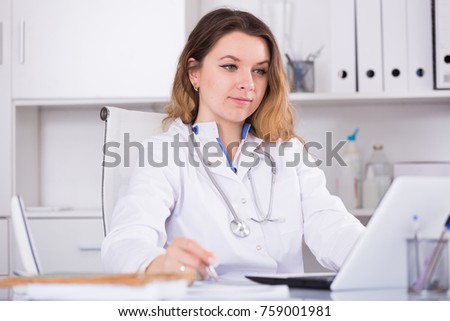 Portrait of young medical worker in medical Center sitting at the table

